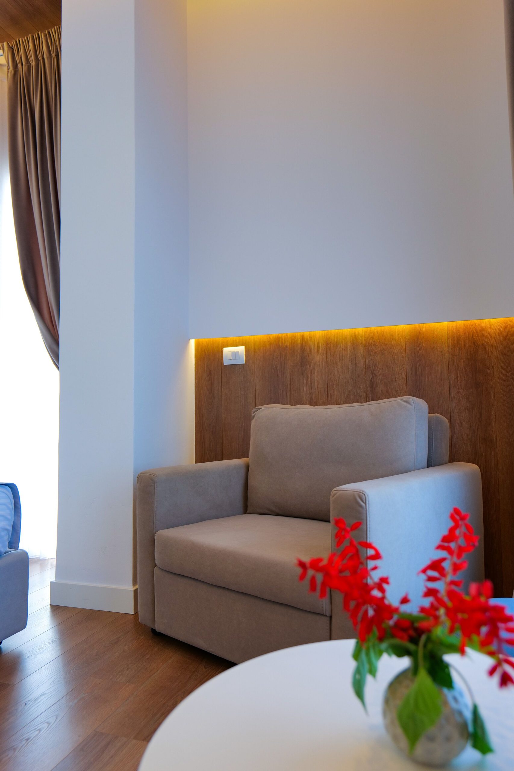 The room's sitting corner, sofa and red flowers